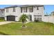 Two-story house with white exterior, black accents, and a two-car garage at 269 Beckenham Dr, Kissimmee, FL 34758