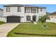 Two-story house with white exterior, black accents, and a two-car garage at 269 Beckenham Dr, Kissimmee, FL 34758