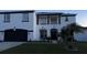 Two-story house with white exterior, black accents, and a two-car garage at 269 Beckenham Dr, Kissimmee, FL 34758