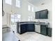 Modern kitchen with dark cabinets, stainless steel appliances, and ample counter space at 269 Beckenham Dr, Kissimmee, FL 34758