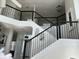 Elegant staircase with black metal balusters and a modern design at 269 Beckenham Dr, Kissimmee, FL 34758