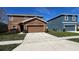 Lovely two-story home with a two-car garage and a well-kept lawn on a sunny day at 627 Lucerne Blvd, Winter Haven, FL 33881