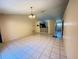 Open concept living room with high ceilings, tiled floors and arched doorways at 796 Del Prado Dr, Kissimmee, FL 34758