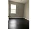 Bedroom with dark laminate flooring and neutral walls at 1645 Cumin Dr, Kissimmee, FL 34759