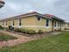 House exterior showcasing a side view with landscaping and a brick walkway at 1645 Cumin Dr, Kissimmee, FL 34759