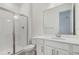 Bathroom features a glass enclosed shower, a sleek vanity and a bright mirror at 1695 Sugarbelle Cir, Mascotte, FL 34753