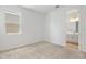 Bedroom featuring neutral carpet, light walls and open bathroom doorway at 1695 Sugarbelle Cir, Mascotte, FL 34753