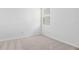 Bedroom featuring neutral carpet, white walls, and a bright window at 1695 Sugarbelle Cir, Mascotte, FL 34753