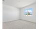 Bright bedroom features neutral carpet, light walls and a window offering natural light at 1695 Sugarbelle Cir, Mascotte, FL 34753