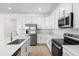 Modern kitchen featuring white cabinets, stainless steel appliances, and a large center island at 1695 Sugarbelle Cir, Mascotte, FL 34753