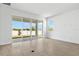 Spacious living room with sliding glass doors leading to the backyard and tile floors at 1695 Sugarbelle Cir, Mascotte, FL 34753