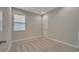 Neutral bedroom featuring a carpeted floor, window with blind, and a white door at 19041 Blueleaf St, Orlando, FL 32827