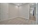 Carpeted bedroom with light walls, a closet door, and an open view to the kitchen at 19041 Blueleaf St, Orlando, FL 32827