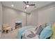 Cozy bedroom with ceiling fan and a view of the television at 19041 Blueleaf St, Orlando, FL 32827