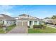 Lovely one-story home with a two-car garage, brick driveway, and lush green lawn, nestled in a suburban neighborhood at 19041 Blueleaf St, Orlando, FL 32827