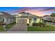 Beautiful two-story home with a brick driveway, two-car garage, and manicured landscaping at 19041 Blueleaf St, Orlando, FL 32827