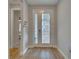 Bright entryway features a glass-paneled door, tile flooring, and neutral paint, leading to the home's interior at 19041 Blueleaf St, Orlando, FL 32827