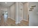 Hallway with light wood-look tile flooring leads to various rooms; 'Giovanni, Harlee, Mattie' wall decor visible at 19041 Blueleaf St, Orlando, FL 32827