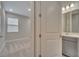 Hallway view to the bedroom and bathroom with modern fixtures and neutral colors at 19041 Blueleaf St, Orlando, FL 32827
