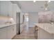 Bright kitchen features white cabinetry, stainless steel appliances, and a view into the dining area and staircase at 19041 Blueleaf St, Orlando, FL 32827