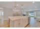 Spacious kitchen island with white countertops, pendant lighting, and stainless steel appliances offers ample workspace at 19041 Blueleaf St, Orlando, FL 32827