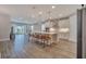 Open-concept kitchen and living area with large island, pendant lighting, and modern appliances creates inviting space at 19041 Blueleaf St, Orlando, FL 32827