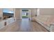 Open-concept living room with sliding glass doors leading to the backyard, featuring wood-look tile floors at 19041 Blueleaf St, Orlando, FL 32827