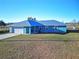 Single story house with metal roof and light blue exterior at 25 Juniper Loop Cir, Ocala, FL 34480