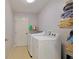 Laundry room with washer, dryer, and storage shelves at 25 Juniper Loop Cir, Ocala, FL 34480