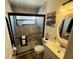 Bathroom with a walk-in shower, white vanity, and a large mirror at 2704 Kendall Ave, Kissimmee, FL 34744