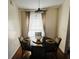 Bright dining room with a round table, four chairs, and large windows at 2704 Kendall Ave, Kissimmee, FL 34744