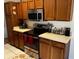 Kitchen with oak cabinets, stainless steel appliances, and a tiled floor at 2704 Kendall Ave, Kissimmee, FL 34744