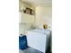 Laundry room with washer, dryer, and overhead cabinets at 2704 Kendall Ave, Kissimmee, FL 34744