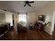 Spacious living room with hardwood floors, a brown leather couch, and sliding glass doors at 2704 Kendall Ave, Kissimmee, FL 34744