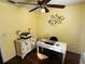 Home office with a white desk, wooden cabinet, and a ceiling fan at 2704 Kendall Ave, Kissimmee, FL 34744