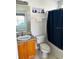 Clean bathroom with tub shower, toilet and wood vanity at 2981 Kokomo Loop, Haines City, FL 33844