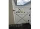 White vinyl gate with an X design, providing access to the backyard at 2986 Aqua Virgo Loop, Orlando, FL 32837