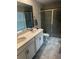Bathroom with double vanity, shower, and tiled floor at 2986 Aqua Virgo Loop, Orlando, FL 32837