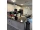 Modern kitchen with white cabinets, gray countertops, and island at 2986 Aqua Virgo Loop, Orlando, FL 32837
