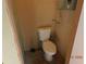 A simple half bath features a white toilet and neutral walls at 436 Michigan Ave, St Cloud, FL 34769