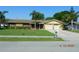Charming single-story home with a well-manicured lawn and mature palm trees at 436 Michigan Ave, St Cloud, FL 34769