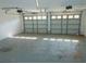 View of a large two-car garage featuring concrete floors and natural light from windows at 436 Michigan Ave, St Cloud, FL 34769