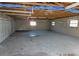 Large garage with exposed beams, concrete floors and multiple windows at 436 Michigan Ave, St Cloud, FL 34769