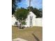 White shed with gray door in grassy backyard at 1107 Jersey Ave, Saint Cloud, FL 34769