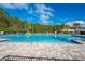 Community pool with lounge chairs and patio at 1242 Iguana Loop, Davenport, FL 33897