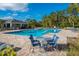 Community pool with seating and cabana at 1242 Iguana Loop, Davenport, FL 33897