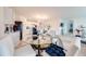 Bright dining area with a glass table and open kitchen view at 1242 Iguana Loop, Davenport, FL 33897