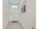 Bright and airy entryway with tile flooring and neutral color palette at 1242 Iguana Loop, Davenport, FL 33897