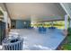 Covered patio area with tables and chairs at 1242 Iguana Loop, Davenport, FL 33897
