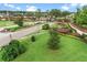 Beautiful gated community entrance featuring manicured landscaping and brick-paved roads at 1280 Osprey Landing Dr, Lakeland, FL 33813
